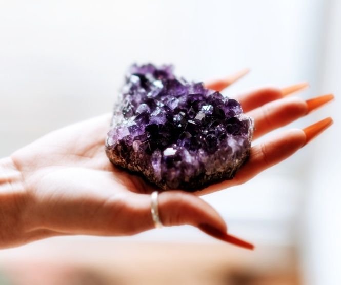 Amethyst crystal cluster held in the palm.  Naan, Naan Design,  Naandesign