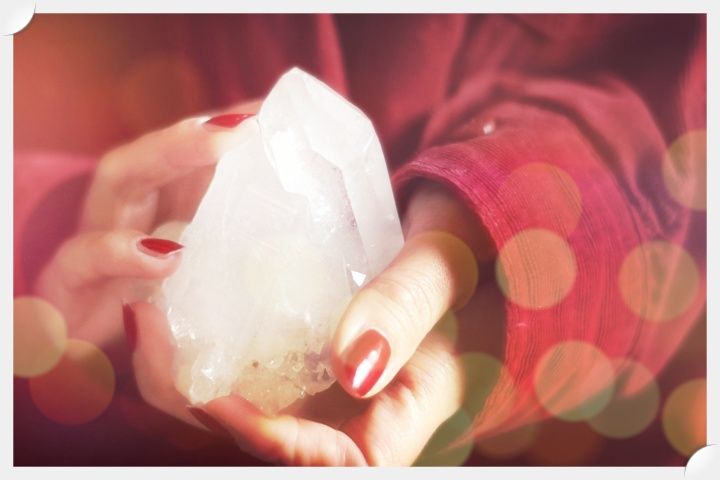 Image of hands holding a piece of selenite.  Naan Design.  Naandesign.