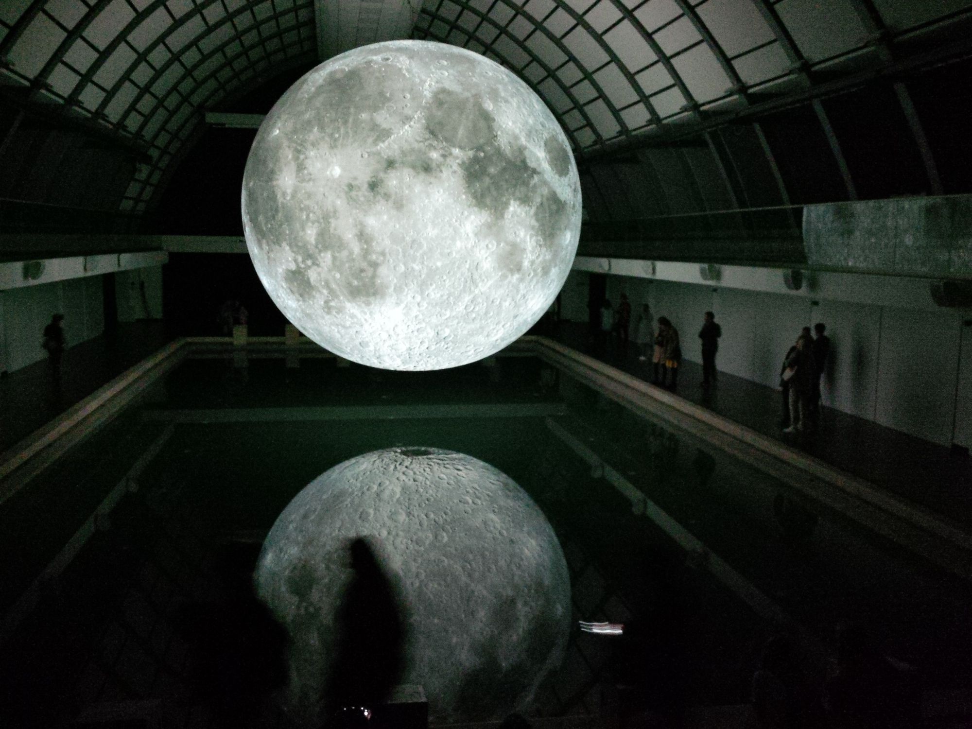 Full moon floating over a pool with reflection